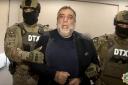 FILE – In this photo taken from video released by State Security Service of the Republic of Azerbaijan on Thursday, Sept. 28, 2023, Ruben Vardanyan, the former head of Nagorno-Karabakh’s separatist government, center, is escorted by Azerbaijani