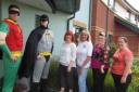 PLEDGE: Callum Davies, Batman, and James Underwood, Robin, with staff from Green Hill Lodge, from left, Wendy Hateley, Chelsie Lane, Emma Lyall and Elizabeth Willis
