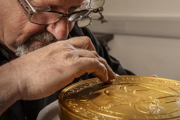 Dudley News: Master craftsman Steve Dyer works on the 15 kilo gold coin by hand. Credit: The Royal Mint