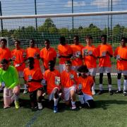 The Benson Community team in their tangerine Sir Stanley Matthews shirts