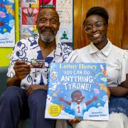 Sir Lenny Henry and illustrator Salomey Doku with Dudley library cards