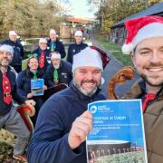 Cllr Wayne Little, Gemma Coley of the Canal & River Trust (in sleigh) with trust volunteers and CRT’s Keith Stevens with Cllr Adam Davies, front right, getting ready for Christmas at Delph Stables.