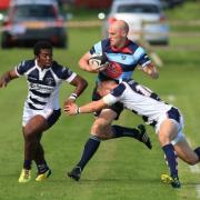 DK's Simon Fletcher is tackled during Saturday's derby loss