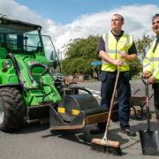 Roadworker Liam Bryant and Councillor Khurshid Ahmed get to grips with the new pothole mending equipment