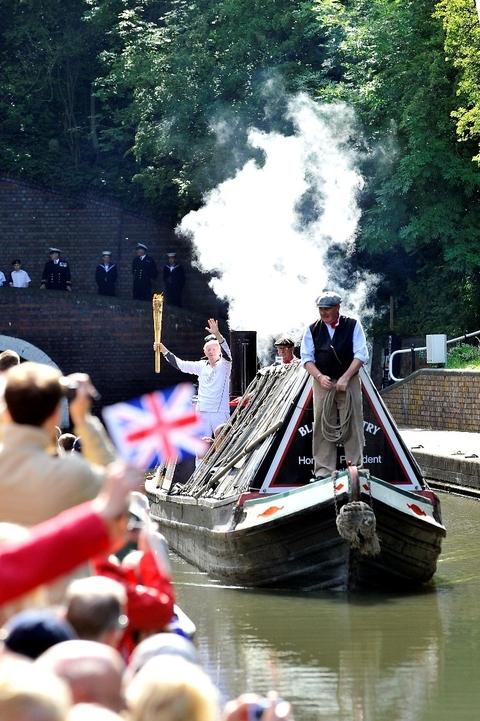 The flame arrives at the Black Country Living Museum on board historic narrow steam boat, President.  Photo by Black Country Living Museum