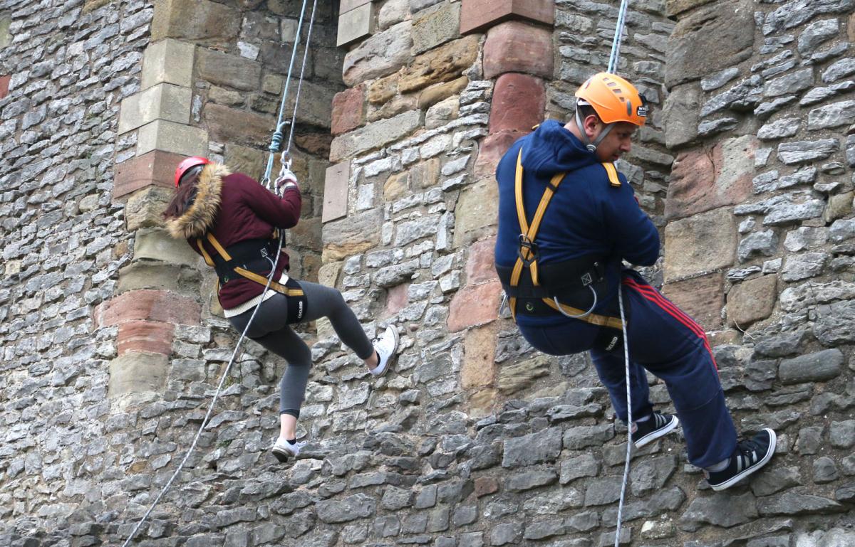 Olivia Bethell, Shaz Saleem climbing down the castle wall