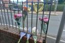 Floral tributes on Thorns Road where a 20-year-old woman died after being knocked down on the pedestrian crossing