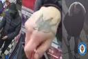 One of the men has a distinctive tattoo on his hand
