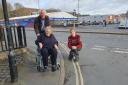 SLOPE: Rae Wood (in the wheelchair) with campaigner  Adam Scott (left) and Tom Collins are concerned by the steep slope and camber at the corner of Union Street and City Walls Road in Worcester