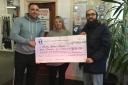 Scott Moore and Rikki Theodosi present a cheque to Mary Stevens Hospice’s Amanda Bowen after their three peaks challenge