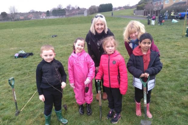 Cllr Karen Shakespeare (back left) plants trees with staff and pupils from Dudley Wood Primary School.
