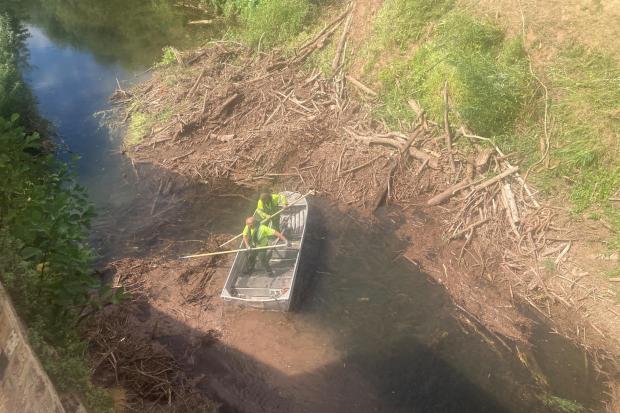 CHALLENGE: A boat crew on the River Teme near the Powick Old Bridge tackle the issue head on. Photo: James Connell