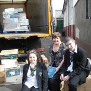 Seeing off the books to Africa are student development officer Kath Cooper and pupils Poppy Smith and Dale Haslam.