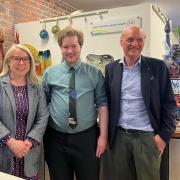 Harrison Davies, centre, with trustee Dr Audrey Whitty, left, and Graham Knowles, chairman of the trustees, right.