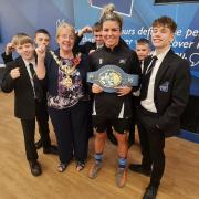 Beacon Hill Academy PE teacher Kirstie Bavington with her European welterweight boxing crown, with the Mayor of Dudley, Cllr Sue Greenaway, and school pupils. Pic - Dudley Council