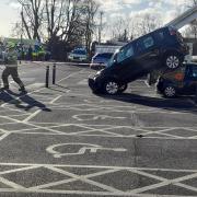 Car ends up on top of another after car park crash