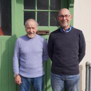 Alan Aston, left, and his brother John, right, outside their old cast iron house which has been recreated at the Black Country Living Museum