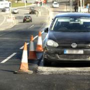 The parked car in Dudley which did not stop workers who resurfaced the road around it