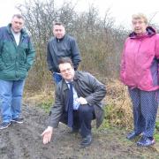 L-R Geoffrey Balden-Smith, Mark Giles, Mike Wood MP and Sue Greenaway show the tracks left by off-road motorcycles at Fens Pool Nature Reserve