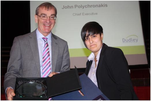 Rachel receiving a previous apprentice of the year award from former Dudley Council chief executive John Polychronakis.